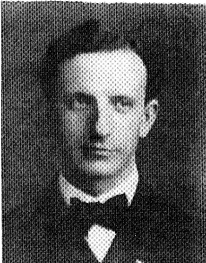 Black and white portrait of a man in a suit and bow tie, with a serious expression.